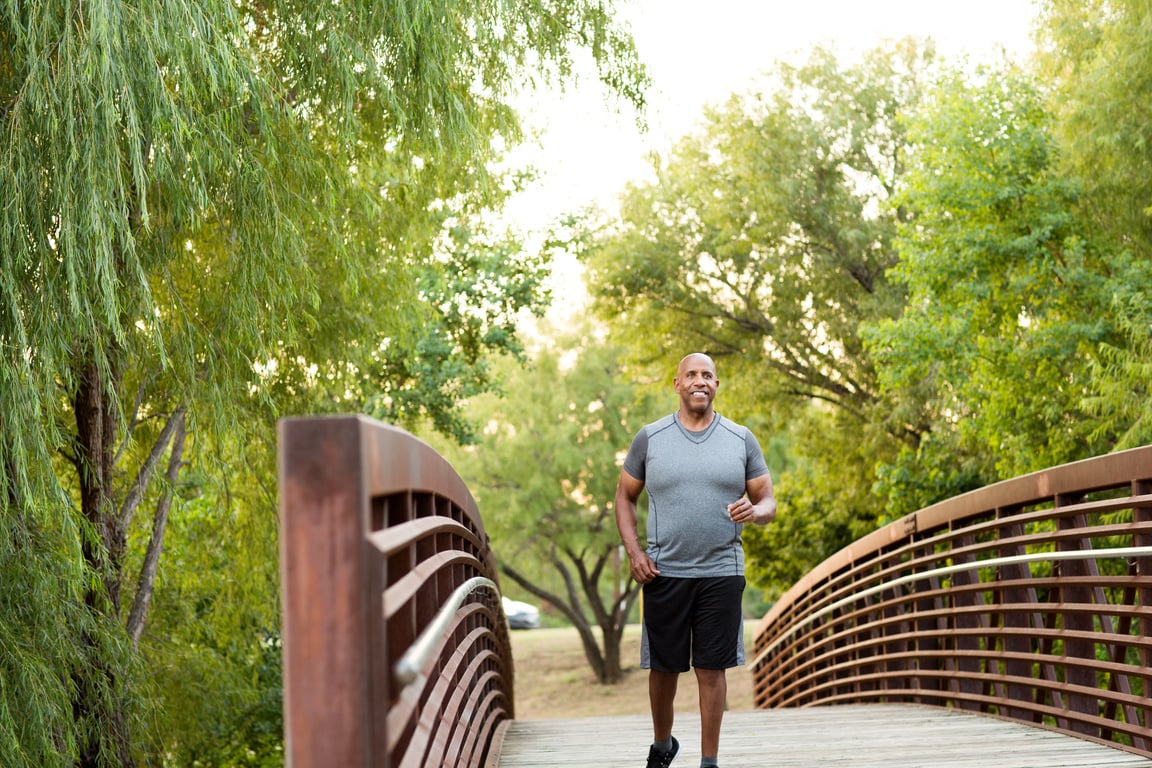 African American man walking in the park.