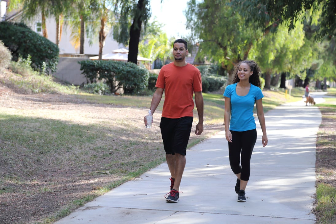 African American Young Couple Walks on Path